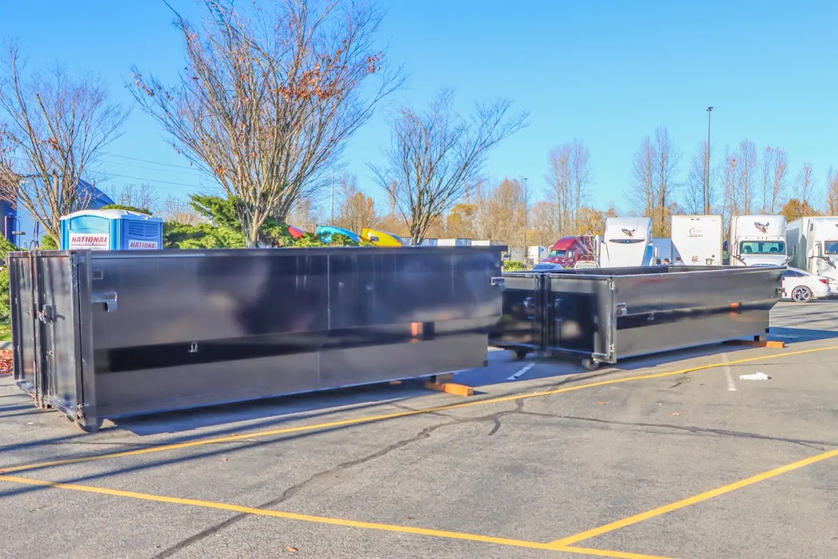 Professional dumpster rental service with roll-off container on residential driveway in Utica